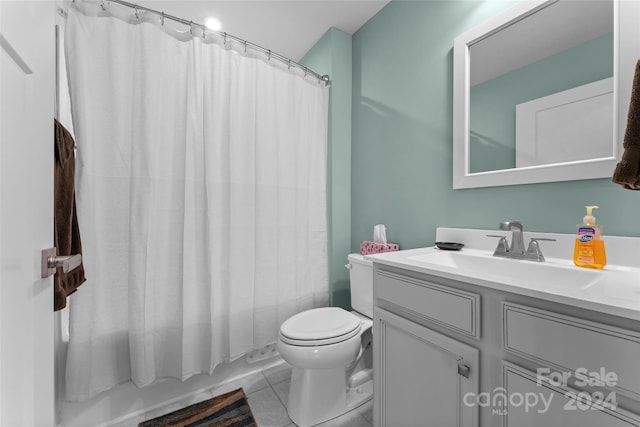 full bathroom with vanity, shower / bath combo with shower curtain, toilet, and tile patterned flooring