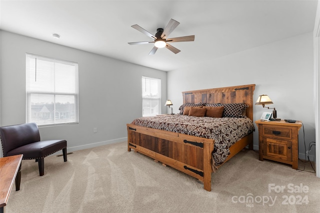 bedroom with light carpet and ceiling fan