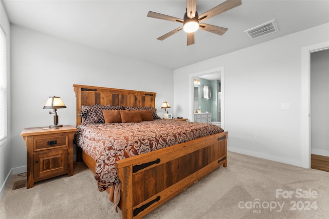 carpeted bedroom featuring ceiling fan and ensuite bathroom