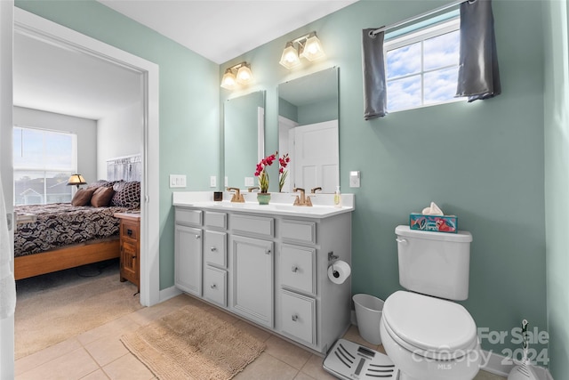 bathroom with vanity, toilet, and tile patterned flooring