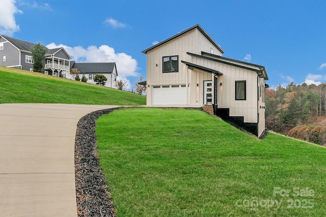 exterior space featuring an attached garage, a front lawn, and board and batten siding