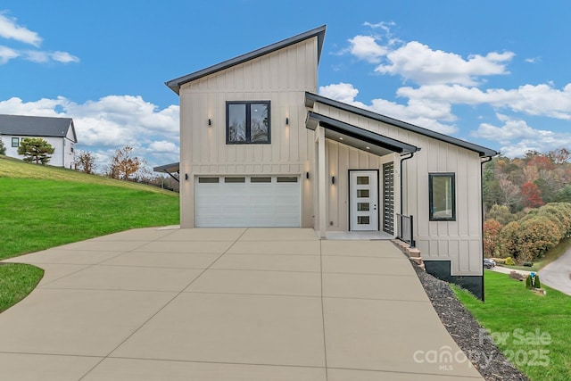 view of front of home with a garage, driveway, a front lawn, and board and batten siding