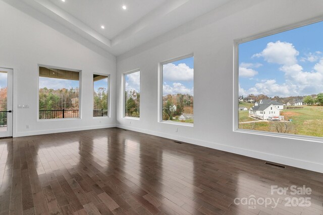 spare room featuring baseboards, visible vents, dark wood finished floors, and recessed lighting