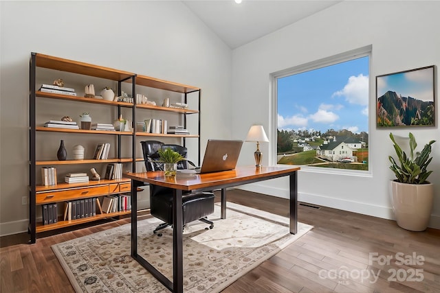 home office with lofted ceiling, dark wood-style flooring, and baseboards