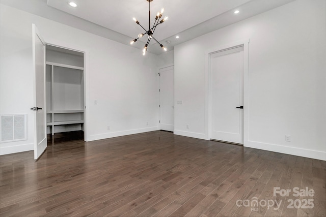 interior space with recessed lighting, visible vents, dark wood finished floors, and a notable chandelier