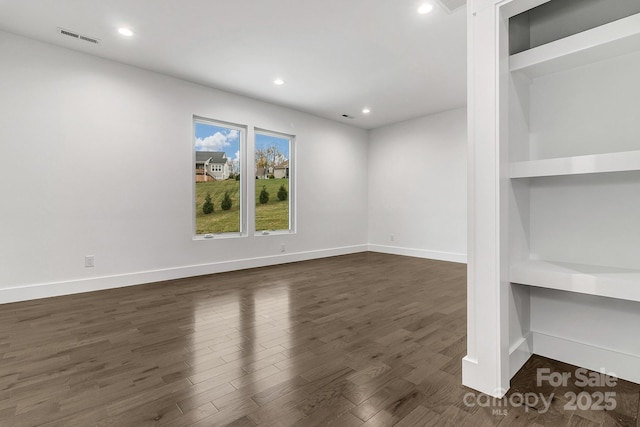 interior space featuring dark wood-style floors, recessed lighting, visible vents, and baseboards