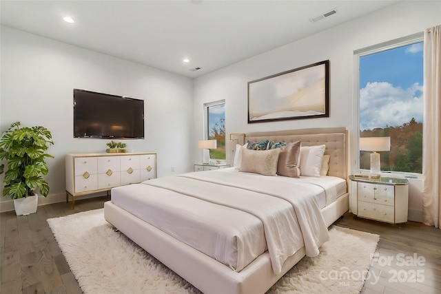 bedroom featuring dark wood-style flooring, visible vents, and recessed lighting