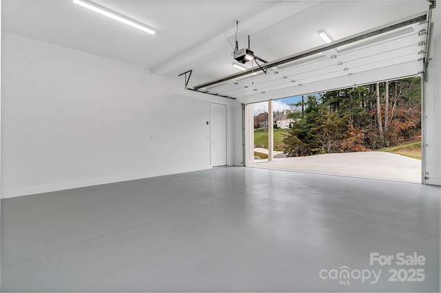 garage featuring a garage door opener and baseboards