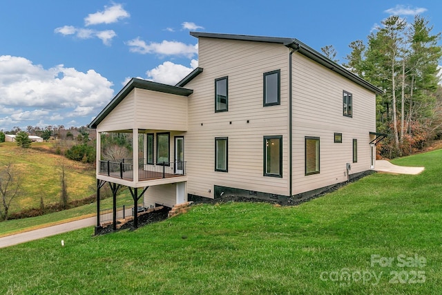 back of property featuring crawl space and a yard