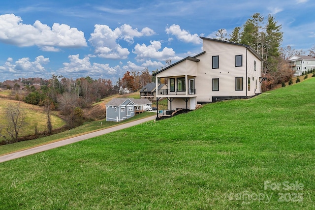 back of house with a lawn