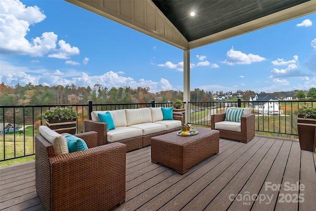 wooden terrace with an outdoor hangout area