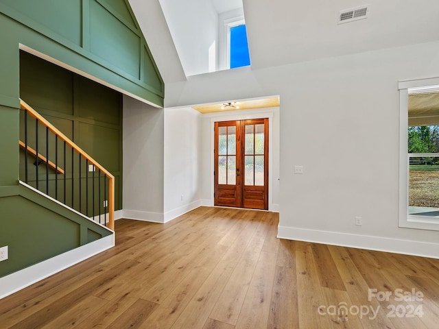 entryway with french doors, light wood-type flooring, and a wealth of natural light