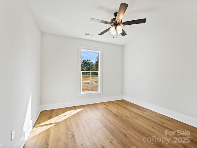 empty room featuring ceiling fan and light hardwood / wood-style flooring