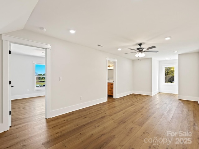 unfurnished room with ceiling fan and wood-type flooring