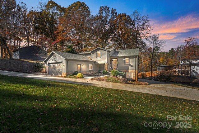 view of front property with a yard and a garage