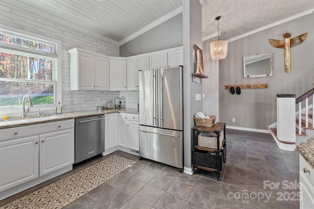 kitchen with decorative light fixtures, white cabinetry, and appliances with stainless steel finishes