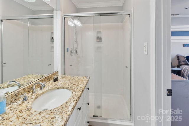 bathroom with vanity, an enclosed shower, and ornamental molding