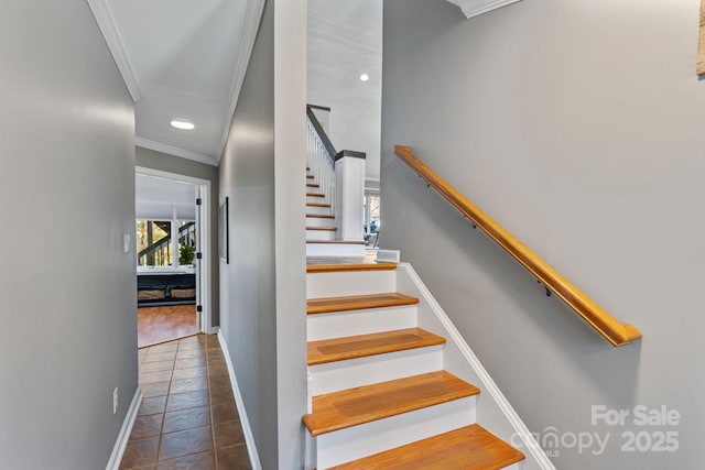 stairway with tile patterned floors and ornamental molding