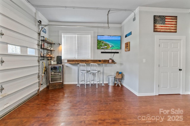 bar with wood-type flooring and beverage cooler