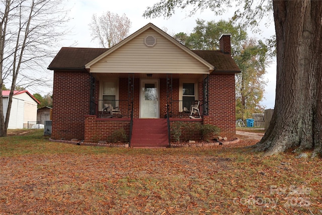 bungalow-style home featuring covered porch and central air condition unit