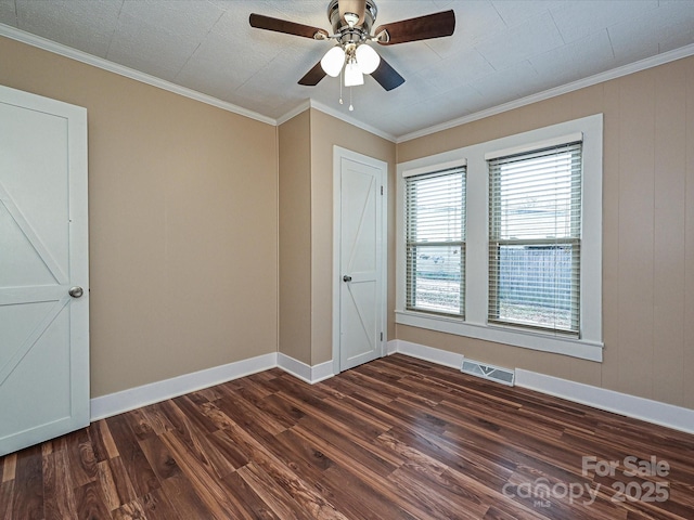 interior space with ceiling fan, ornamental molding, dark hardwood / wood-style flooring, and multiple windows