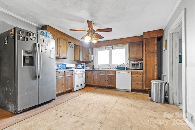 kitchen with a textured ceiling, sink, ceiling fan, crown molding, and white appliances