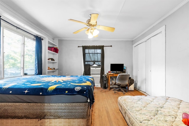 bedroom with hardwood / wood-style flooring, ceiling fan, and crown molding