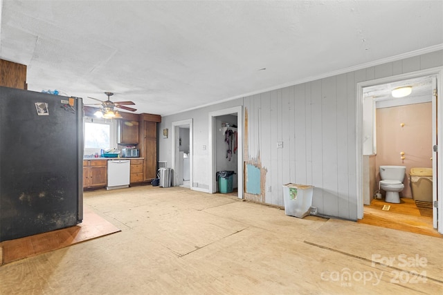 unfurnished living room featuring ceiling fan and crown molding