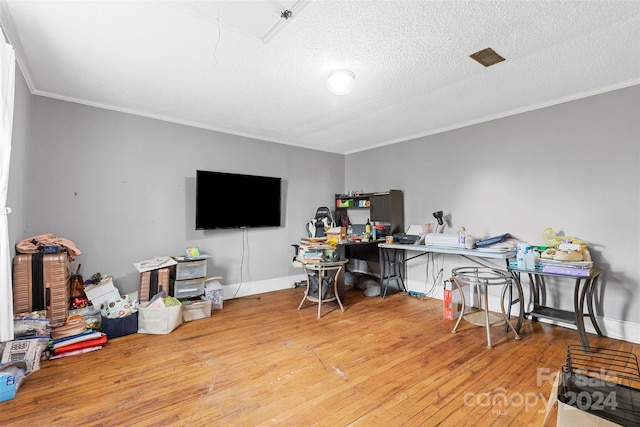 office featuring wood-type flooring, ornamental molding, and a textured ceiling