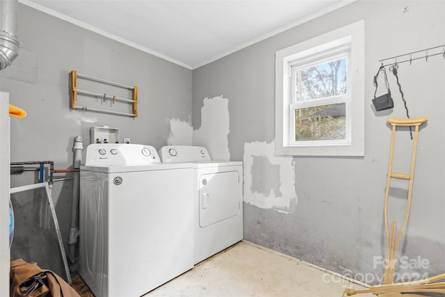 laundry room with separate washer and dryer and crown molding