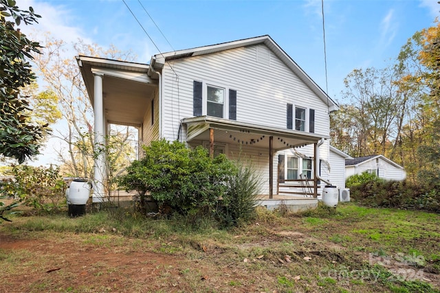 back of house featuring covered porch