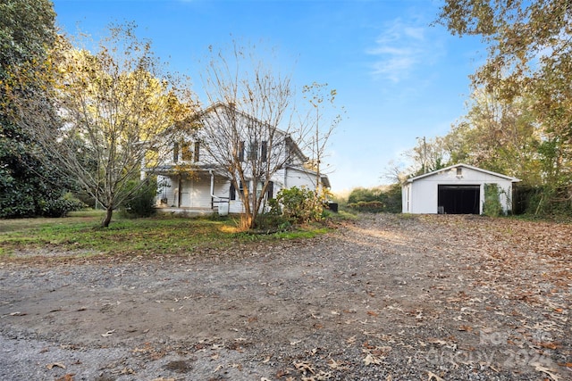 view of front of home featuring a garage and an outdoor structure