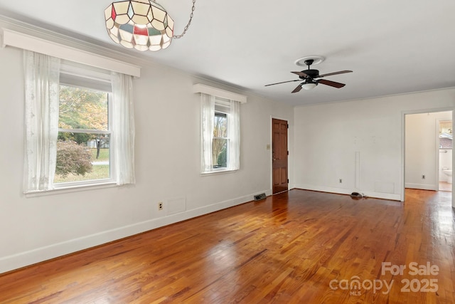 spare room featuring hardwood / wood-style flooring, a wealth of natural light, and ceiling fan