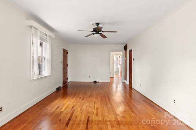 empty room with hardwood / wood-style floors, ceiling fan, and ornamental molding