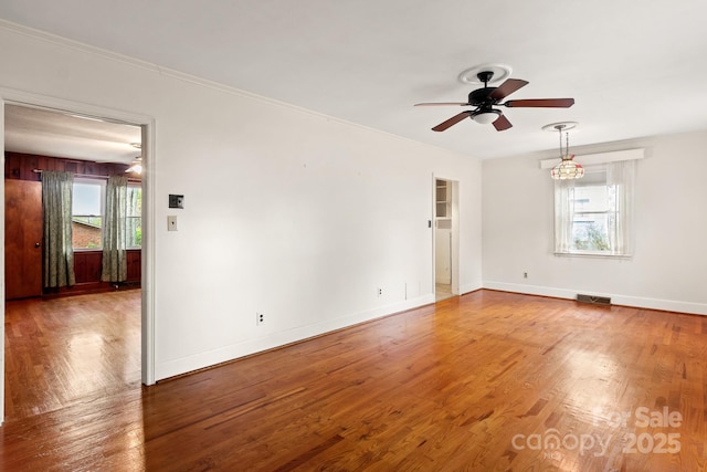 empty room with ceiling fan and wood-type flooring