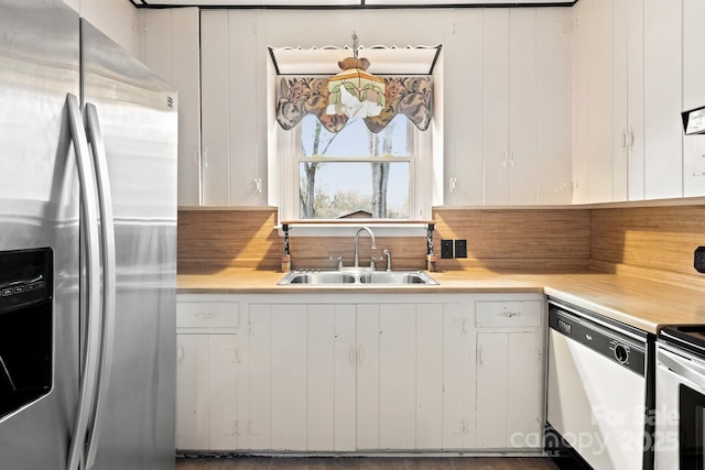 kitchen with stainless steel refrigerator with ice dispenser, stove, white cabinets, sink, and dishwasher