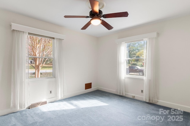 carpeted empty room featuring ceiling fan