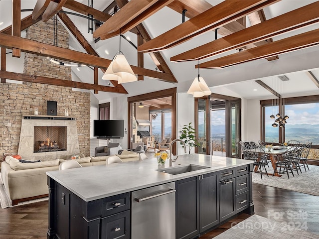 kitchen featuring pendant lighting, a center island with sink, a wealth of natural light, and sink