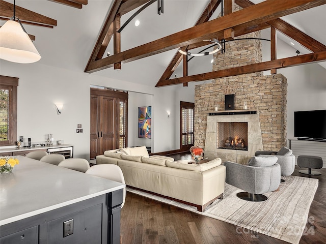 living room with a stone fireplace, dark hardwood / wood-style flooring, beam ceiling, and high vaulted ceiling