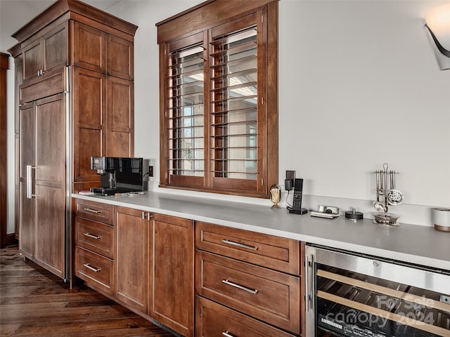 bar featuring beverage cooler and dark hardwood / wood-style floors