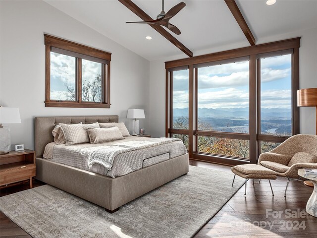 bedroom featuring a mountain view, wood-type flooring, vaulted ceiling with beams, and ceiling fan