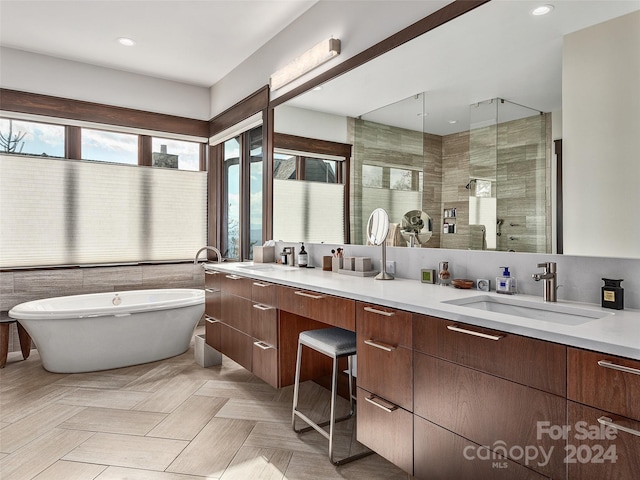 bathroom featuring vanity and plus walk in shower