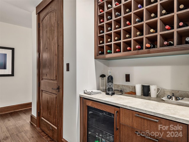 wine room with wine cooler and dark hardwood / wood-style flooring