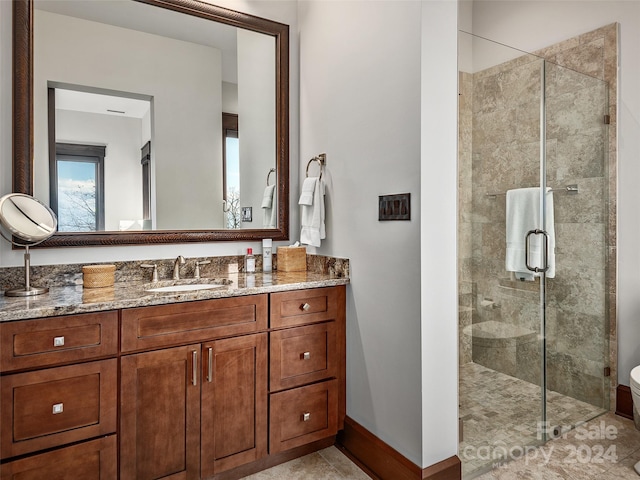 bathroom with tile patterned flooring, vanity, and walk in shower