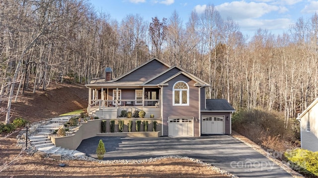 front facade featuring a porch and a garage