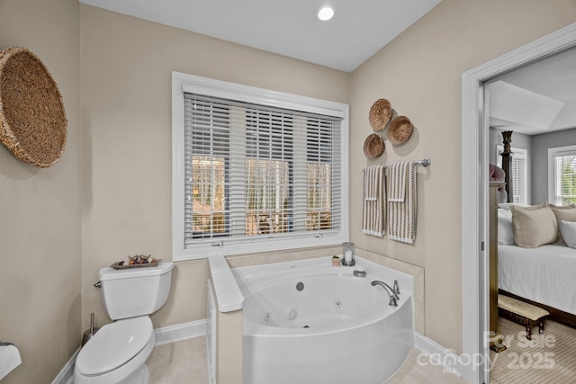 bathroom featuring a tub, tile patterned floors, and toilet