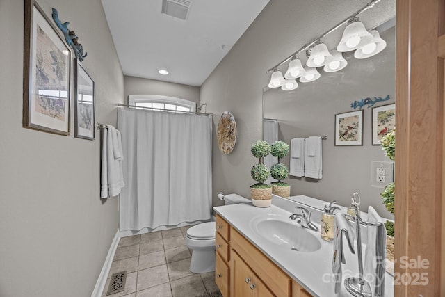 bathroom featuring tile patterned floors, vanity, and toilet