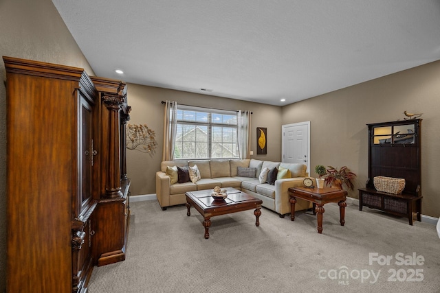 living room featuring a textured ceiling and light colored carpet