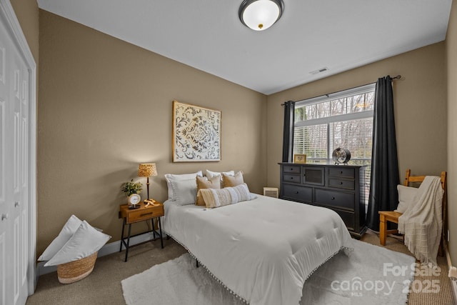 bedroom with light carpet and a closet