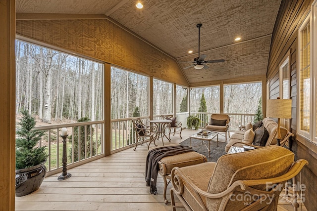 sunroom / solarium with wood ceiling, vaulted ceiling, and ceiling fan